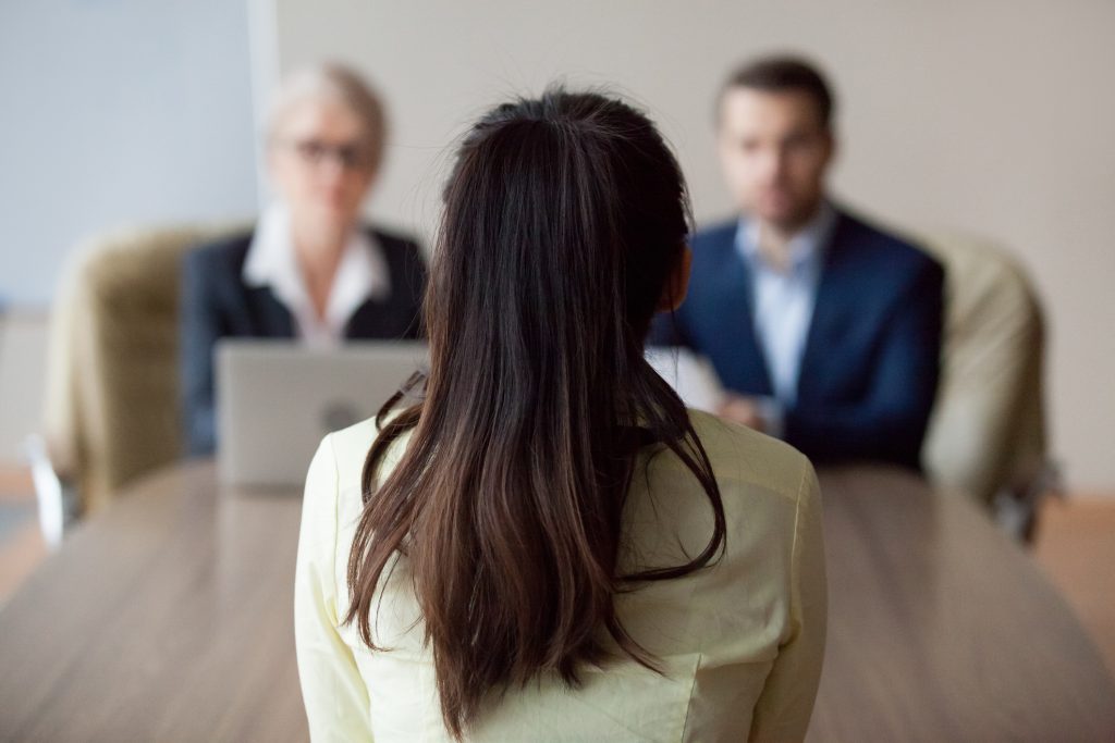 Businesswoman and businessman interviewing woman