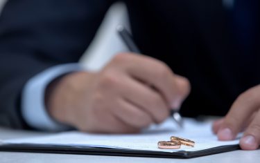 lawyer writing nuptial agreement